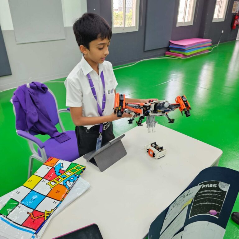 student playing with his robot