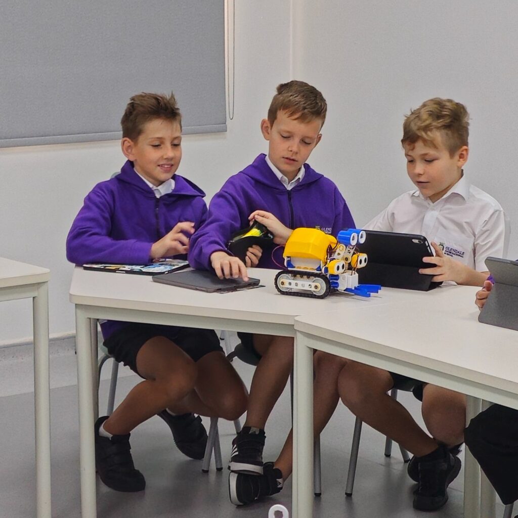 three students working on the robot