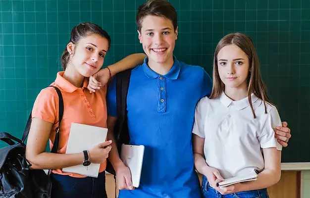 school-friends-posing-front-blackboard