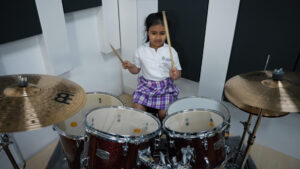 student playing with the drums in music class